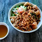 BBQ noodle bowl (bun thit nuong) with egg rolls, shredded vegan pork, and herbs at Saigon Vegan in Garden Grove, CA