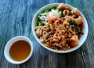 BBQ noodle bowl (bun thit nuong) with egg rolls, shredded vegan pork, and herbs at Saigon Vegan in Garden Grove, CA