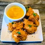 Close-up of the crispy orange cauliflower appetizer with house-made orange sauce at Saigon Vegan in Garden Grove, CA
