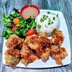 Crispy breaded orange cauliflower in house-made orange sauce, served with rice at Saigon Vegan in Garden Grove, CA
