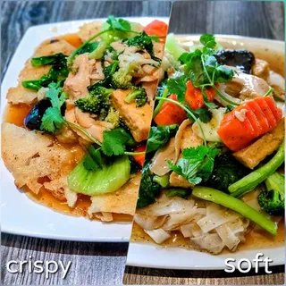 Pan-fried rice noodles (pho ap chao) with vegan chicken, tofu, and broccoli at Saigon Vegan in Garden Grove, CA